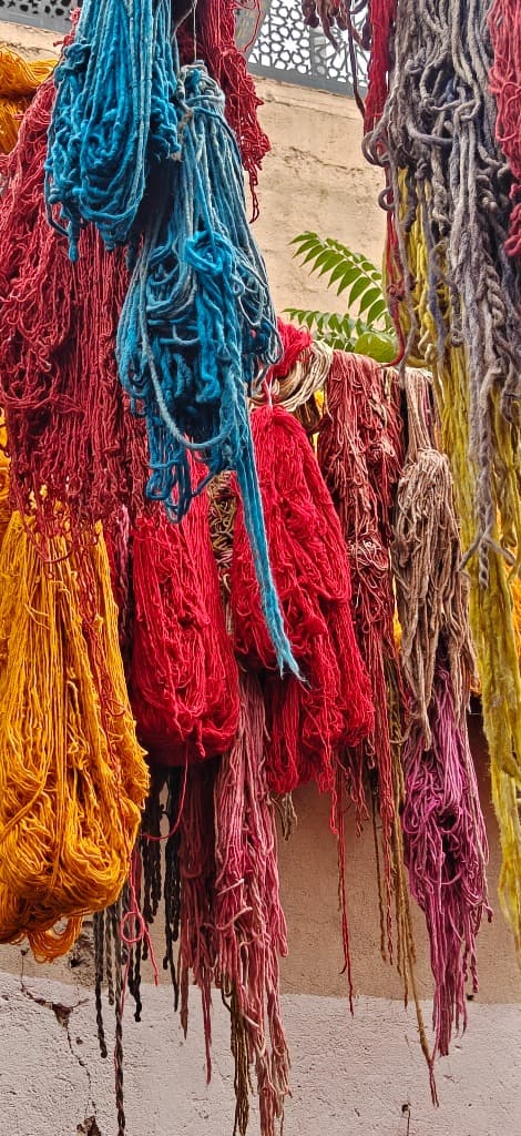 Hanging bundles of bright dyed yarn